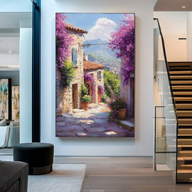 Stone hamlet draped in purple bougainvillea along a sunlit cobbled lane