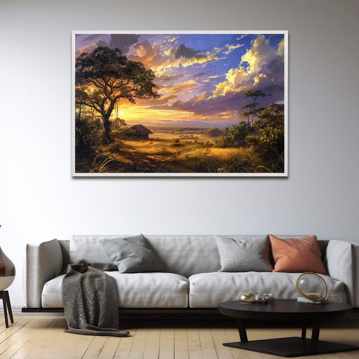 Golden sunset over African savannah with silhouetted tree and thatched hut