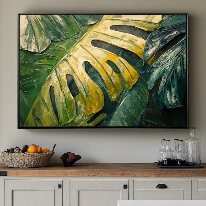 Single monstera leaf in green and gold with the look of thick impasto