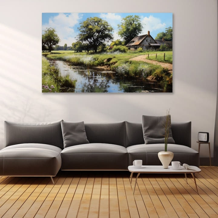 Thatched stone farmhouse beside a stream in a summer meadow with oak trees