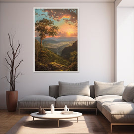 Framed mountain valley landscape at sunset with a lone tree on a rocky ridge
