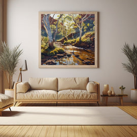 Bush creek scene with pale gum trees, golden reflective water and red sandstone cliffs