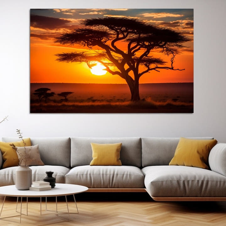 Savannah sunset glowing behind a dark acacia tree silhouette