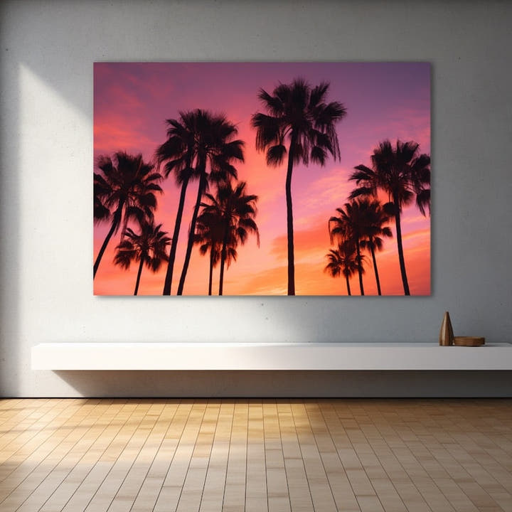 Palm trees silhouetted against a pink and coral sunset sky