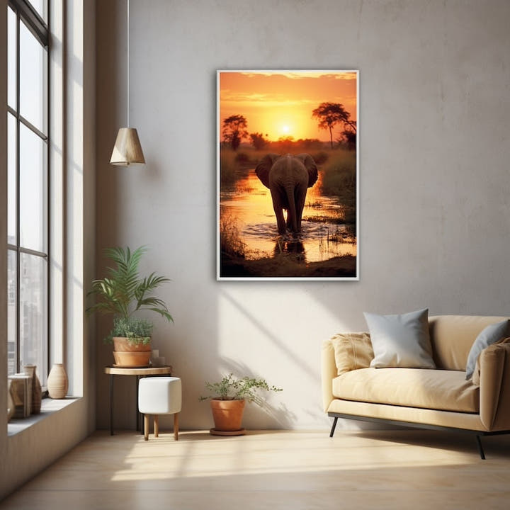 Elephant wading through water at sunset under a blazing orange sky
