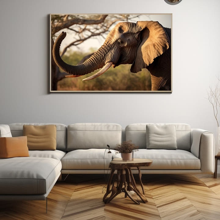 Close profile of an African elephant with its trunk raised in golden light