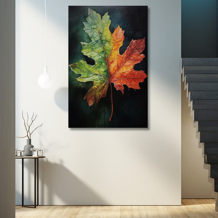 Maple leaf turning from green to fiery red against a black background
