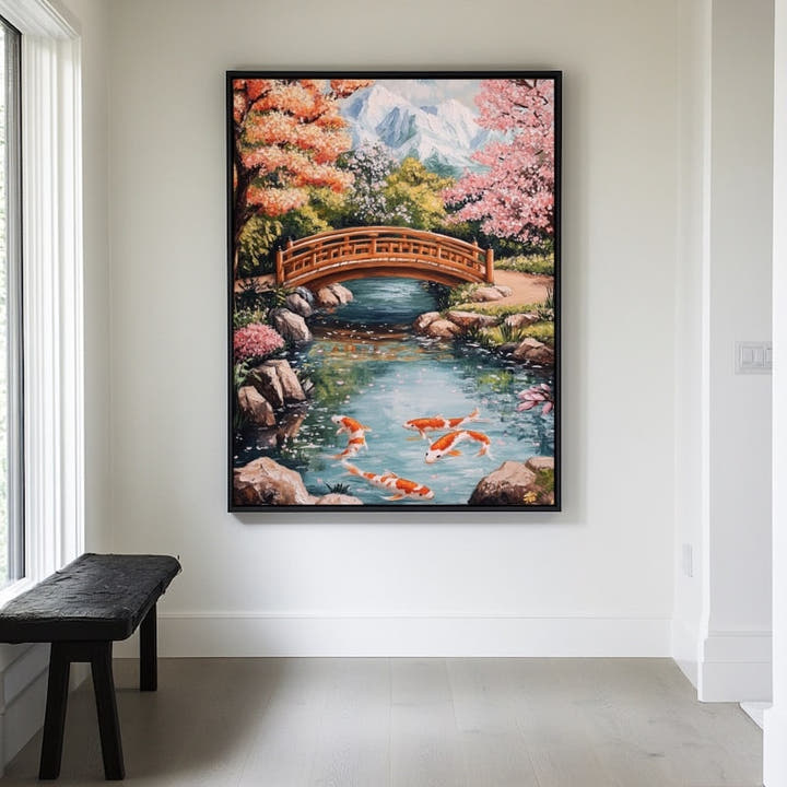 Arched bridge over a koi pond with cherry blossom and mountains