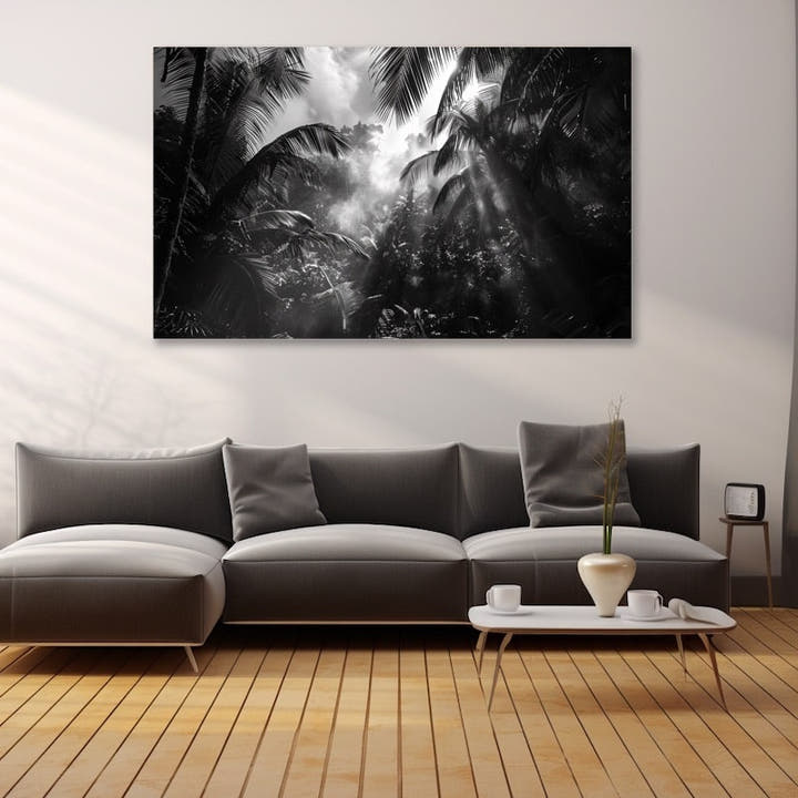 Black and white palm jungle canopy with sunbeams through mist
