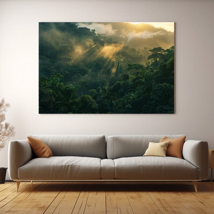 Golden sunrise rays piercing low cloud above a dense rainforest canopy