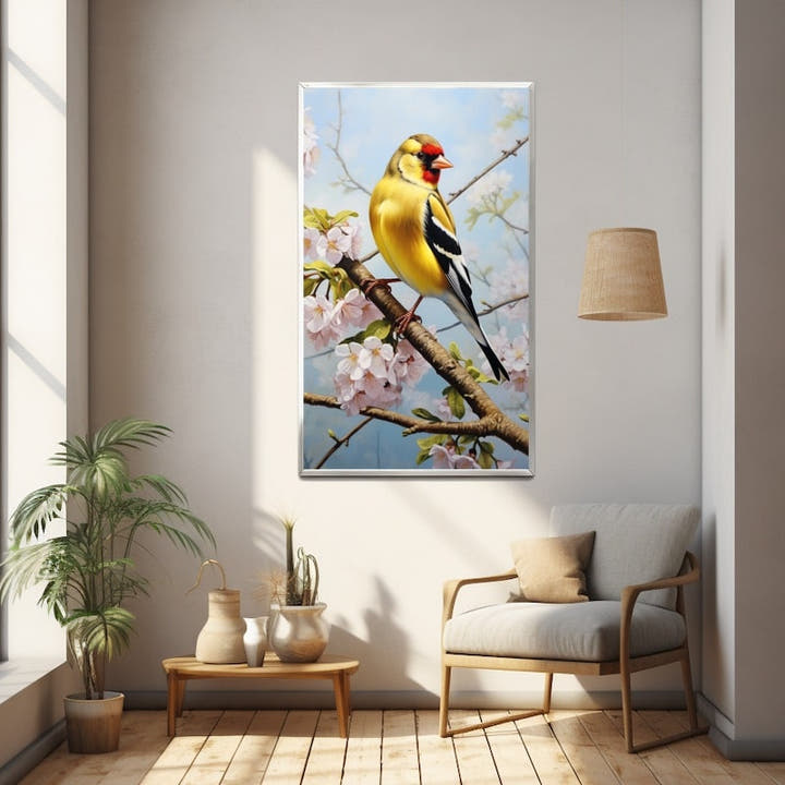 Goldfinch perched among pink cherry blossom