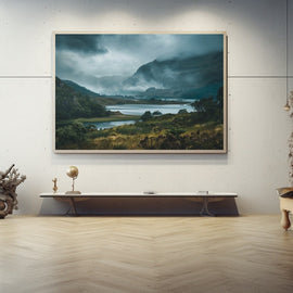Misty Scottish Highland glen with a still loch beneath storm clouds and rugged peaks