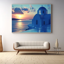 Blue-domed Greek church above the caldera at sunset over calm water