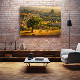 Lone tree on a golden hillside above a terraced plateau