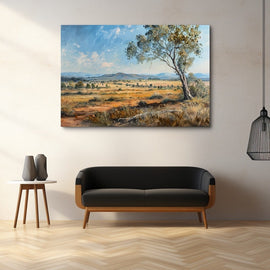 Lone eucalyptus tree on a golden plain with blue hills