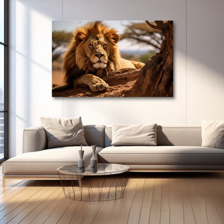 Lion with golden mane reclining by a tree on the savannah
