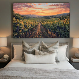 Sunlit vineyard rows with purple grapes under an apricot evening sky